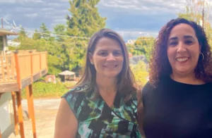 Photo of Deidre McCormack Martin, Executive Director, and Veronica Quinonez, 2024 Board President, standing outside together on a deck.